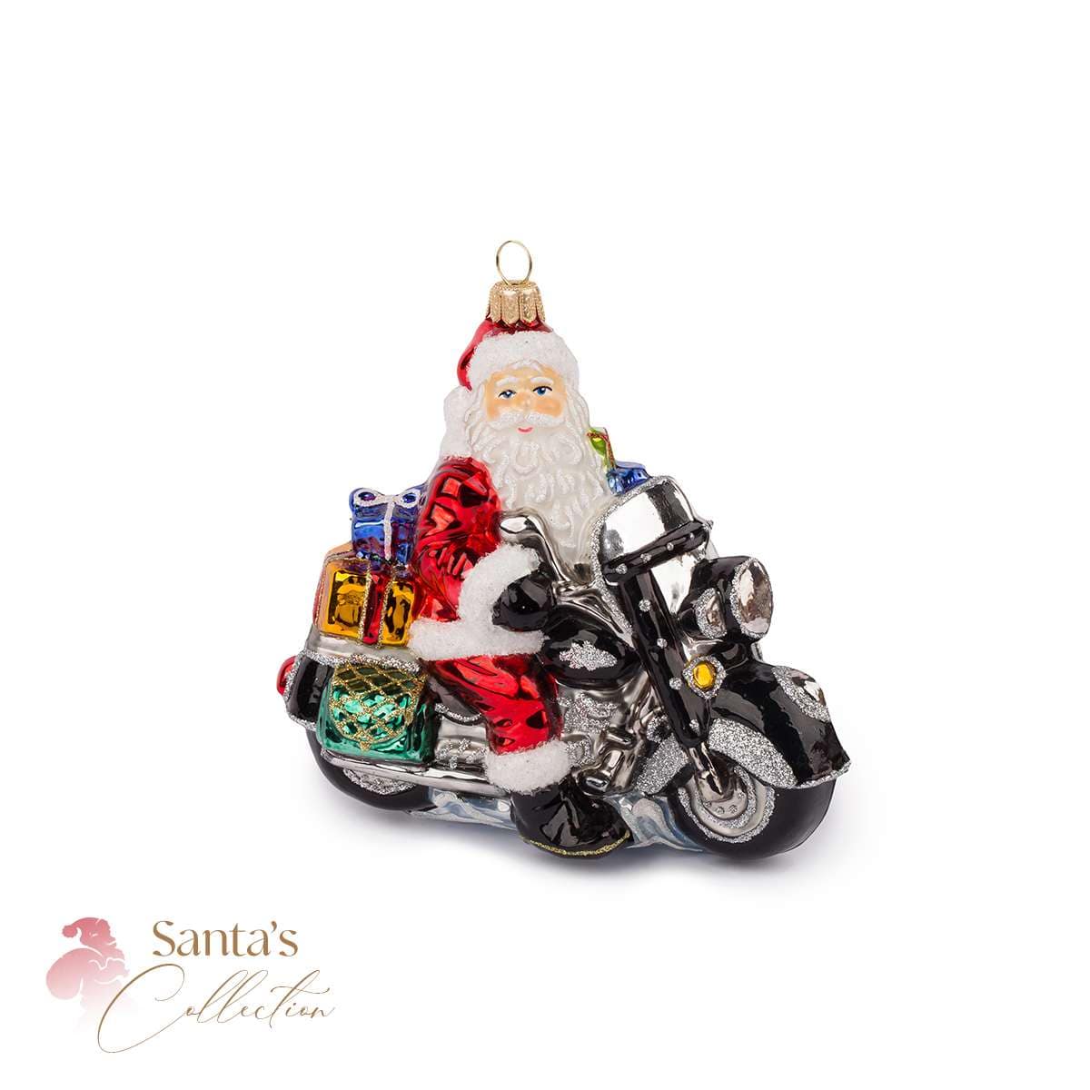 Le Père Noël Sur Une Moto à Travers Un Village Enneigé | Image Premium